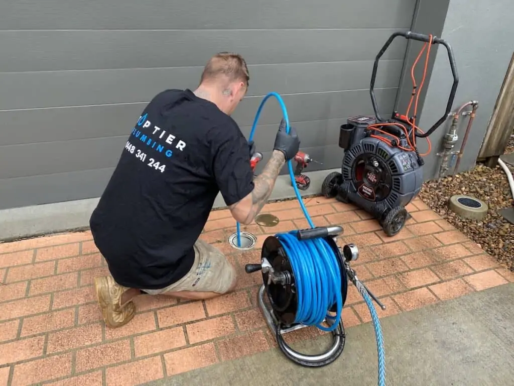 expert clearing a blocked drain in South Brisbane