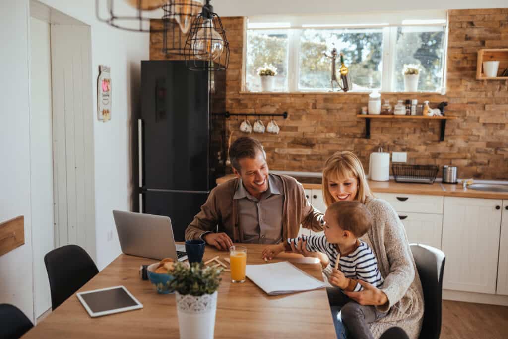 Family sitting at dining table in kitchen